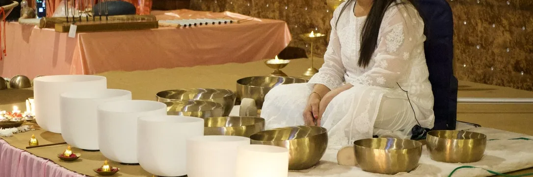 A row of crystal and Tibetan singing bowls before a session