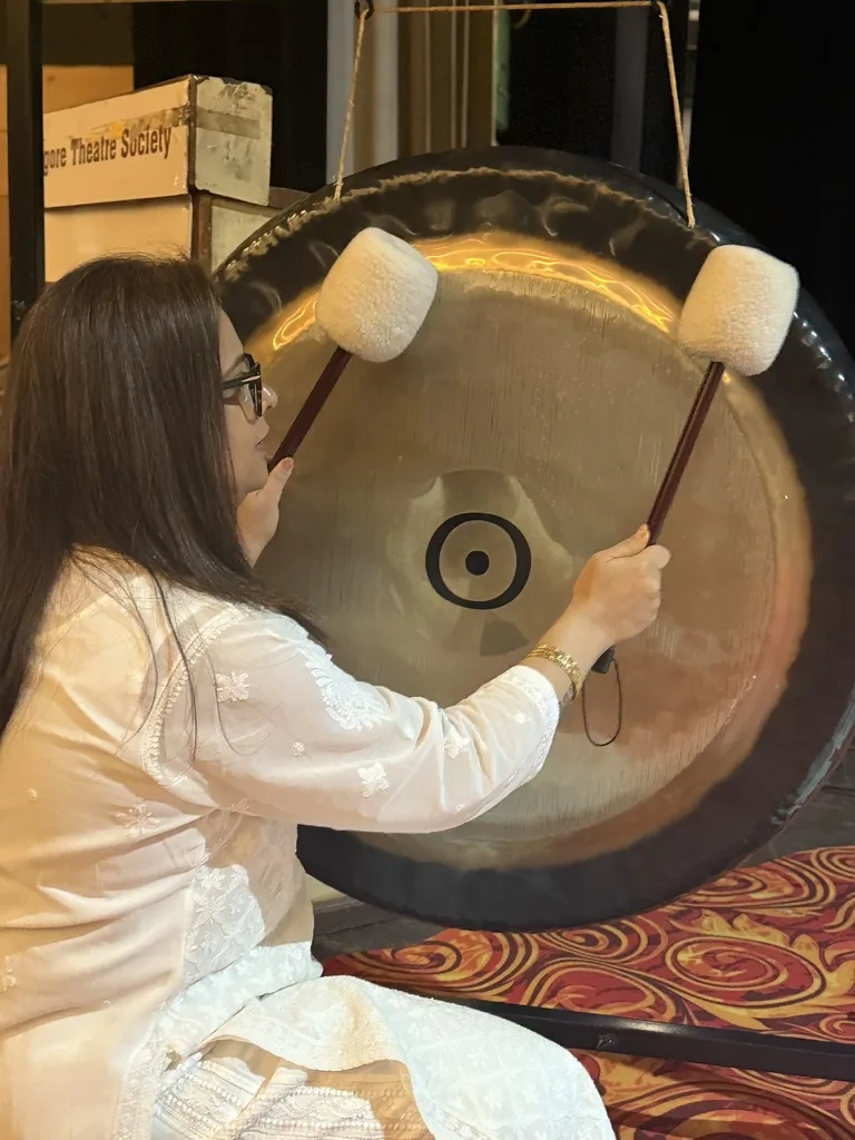 Pooja playing a gong