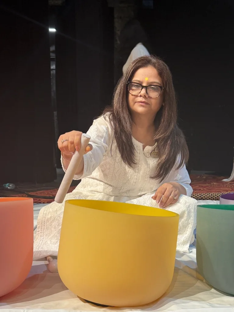 Pooja playing a crystal singing bowl